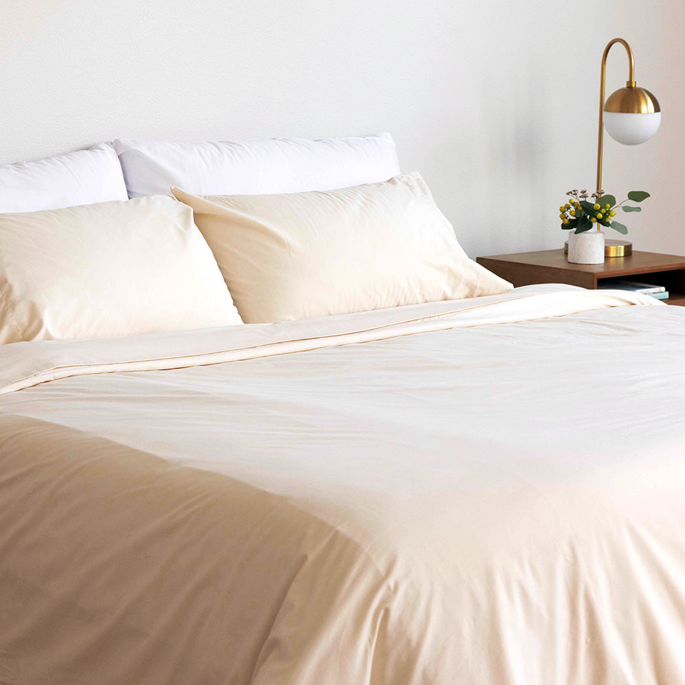 Bed made up with a Rustic Cotton set of Heritage American Sheets, Cloud White & Rustic Cotton Envelope Closure PIllowcases, and a Rustic Cotton A50 Duvet Cover.