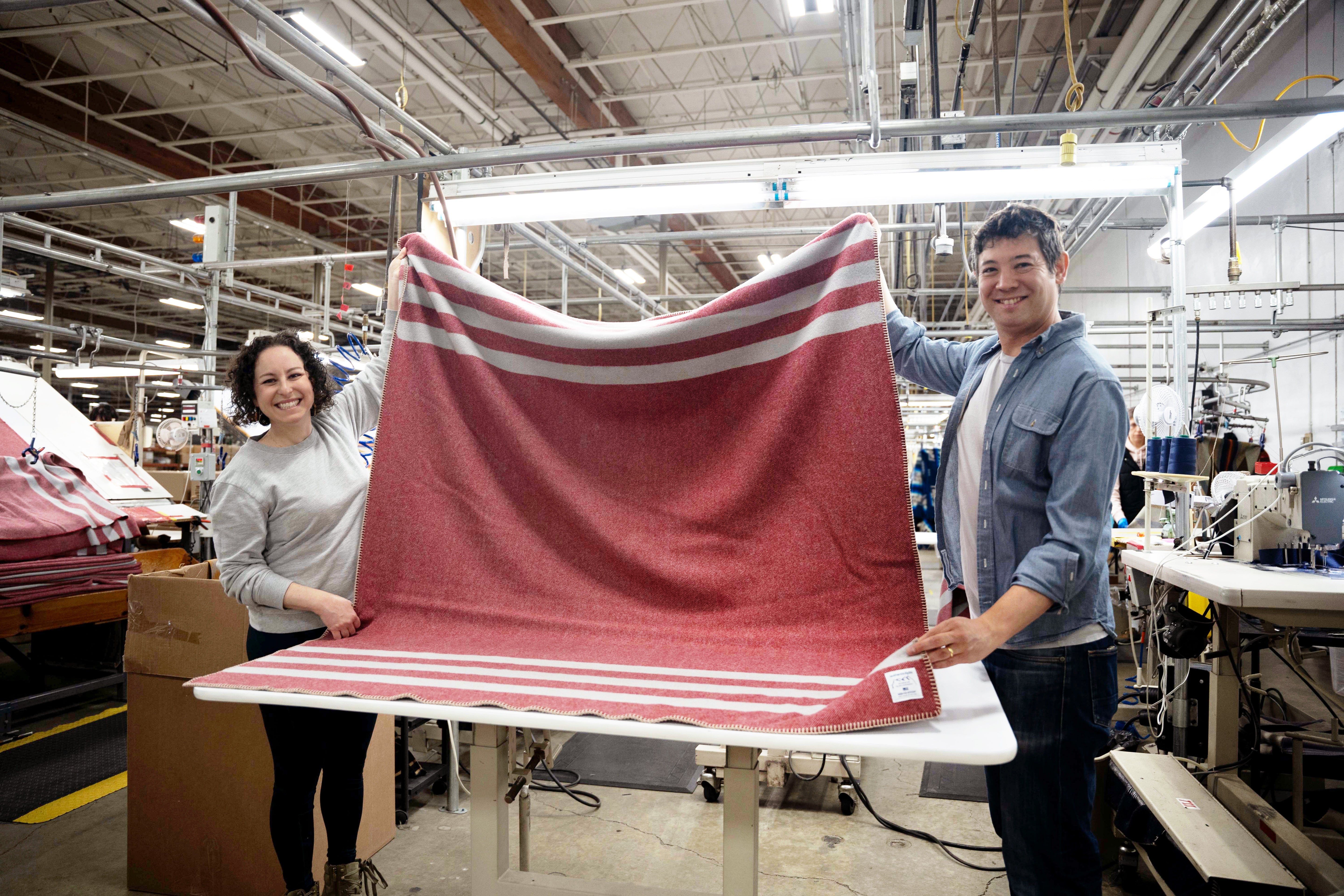 Authenticity50 co-founders Steph and Jimmy MacDonald holding one of the first samples of the Northwest Wool Throw.