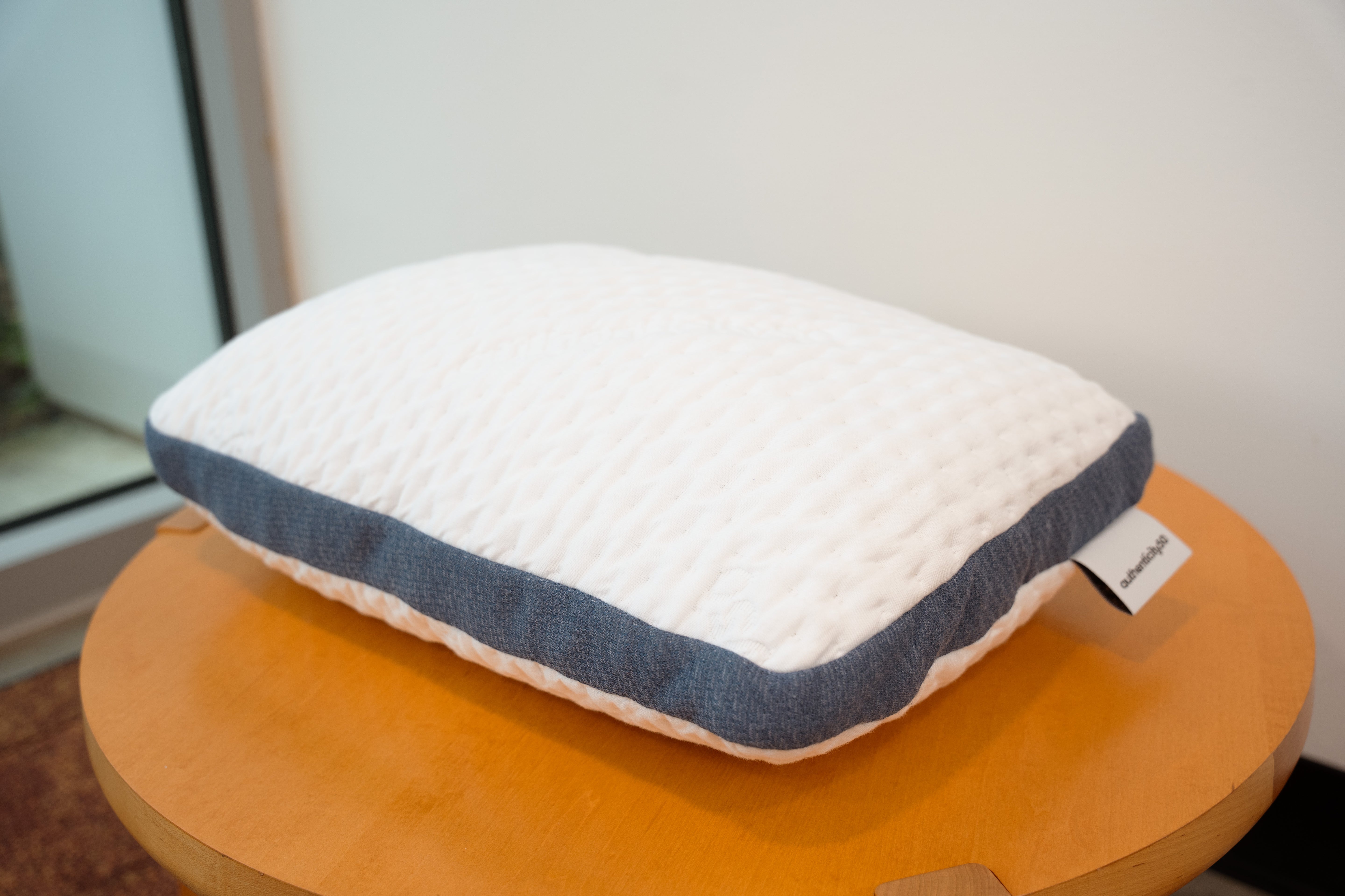 A50 Travel Pillow sitting on a small coffee table.