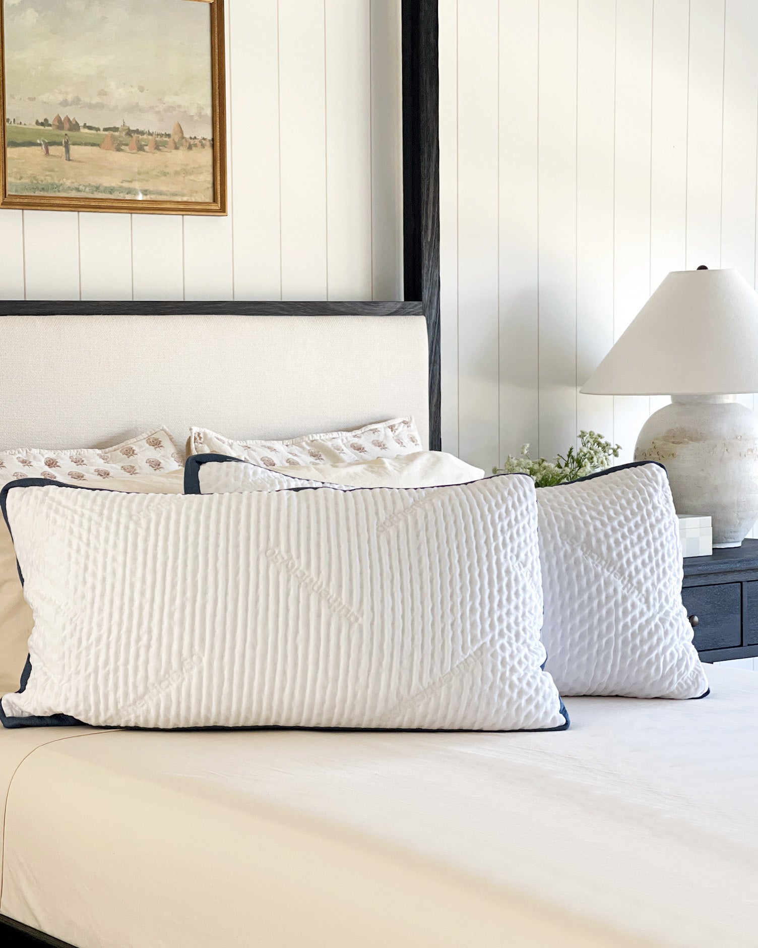 Two Custom Comfort Pillows propped up on a bed made with Heritage American Sheets.