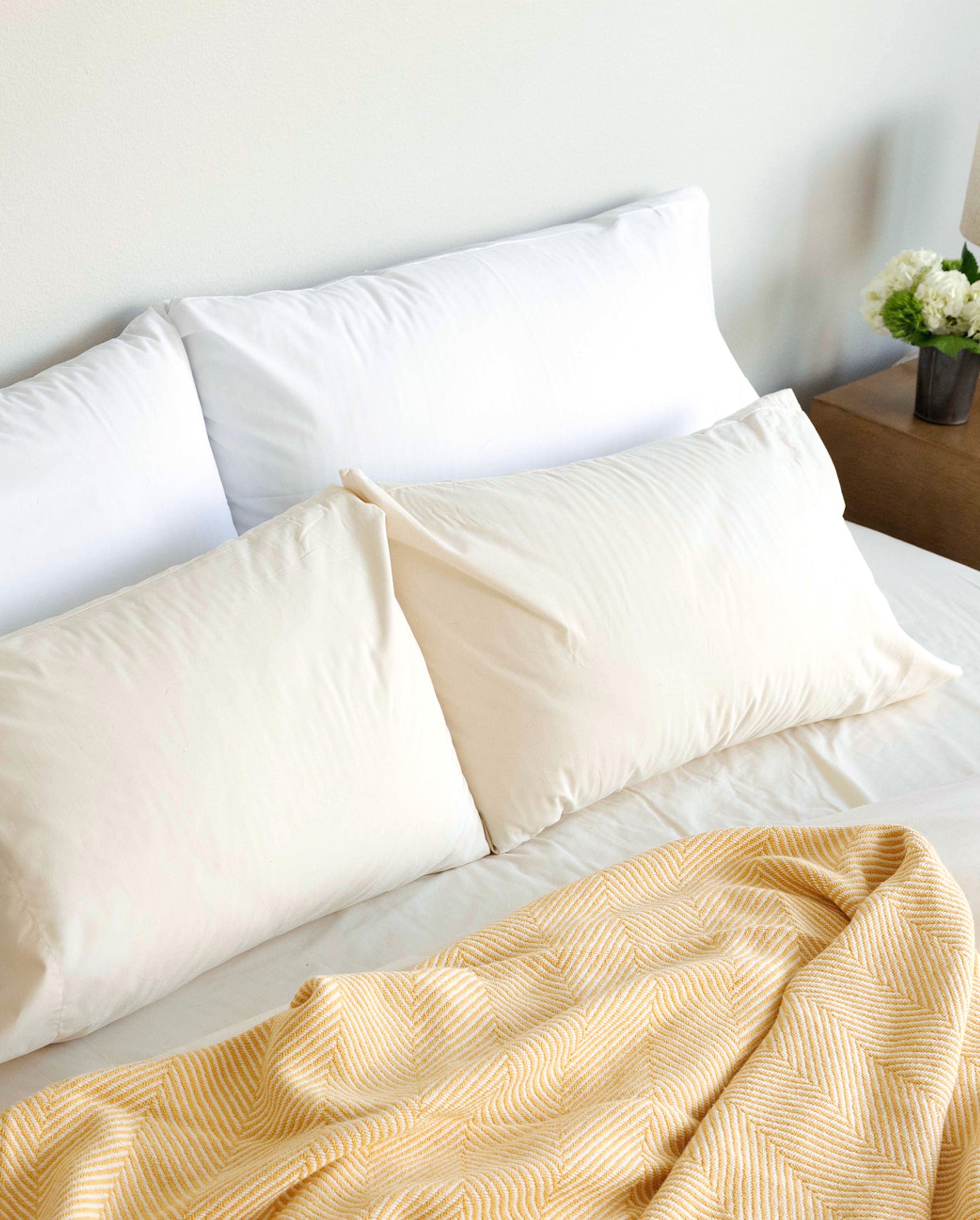 Four pillows tucked into Rustic cotton and Cloud White Envelope Closure Pillowcases.