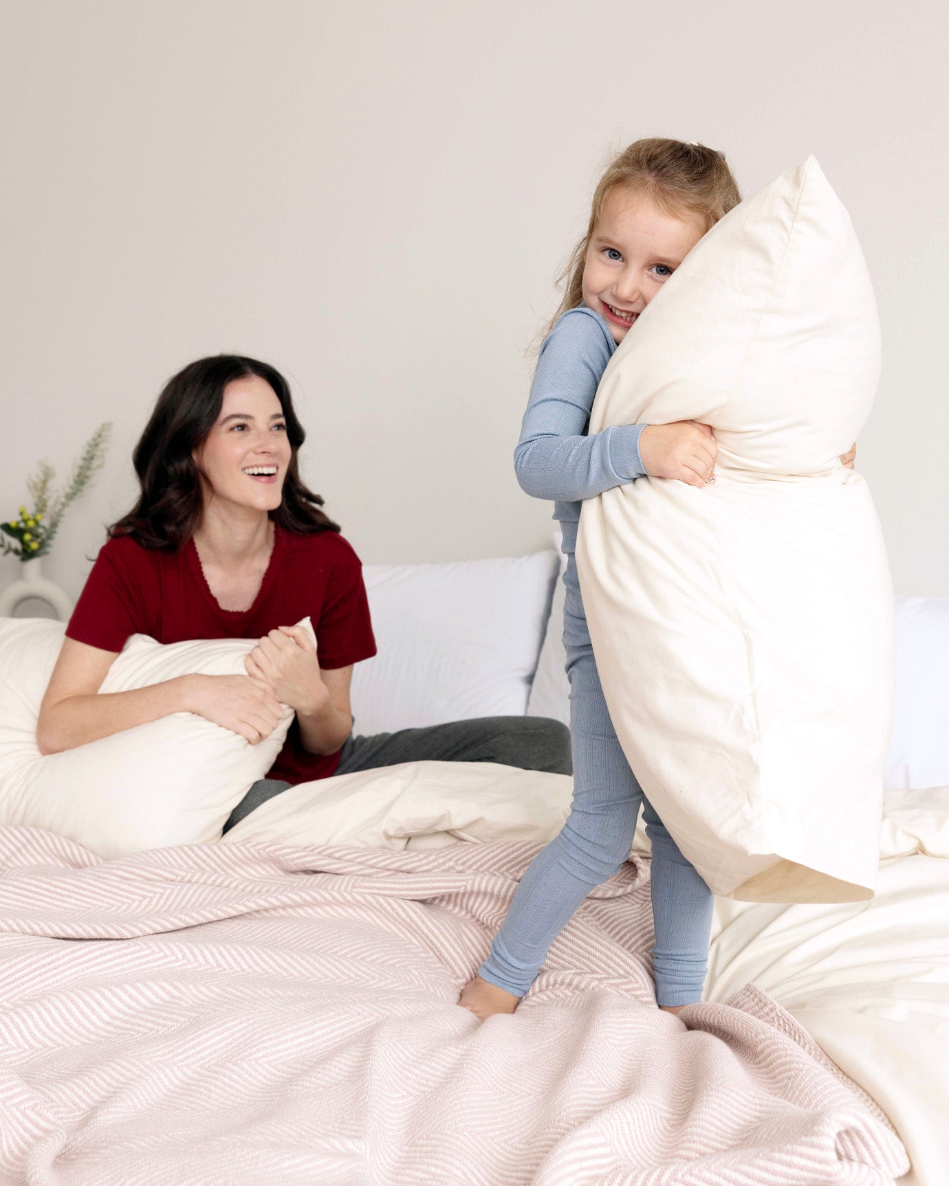 Mother and daughter hugging their Custom Comfort Pillows.