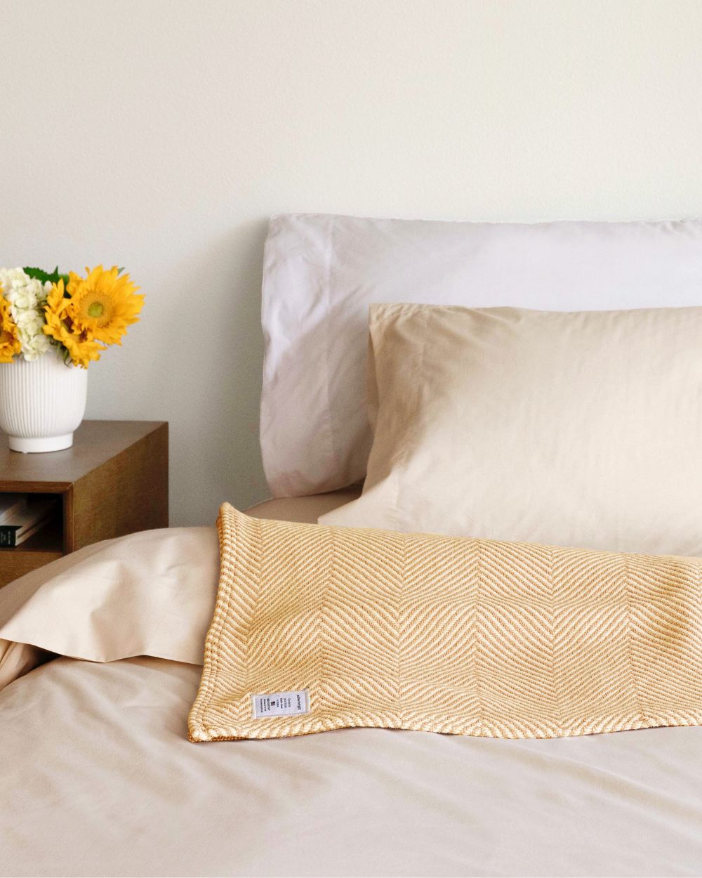 Prairie Yellow Heritage Blanket folded on a bed.
