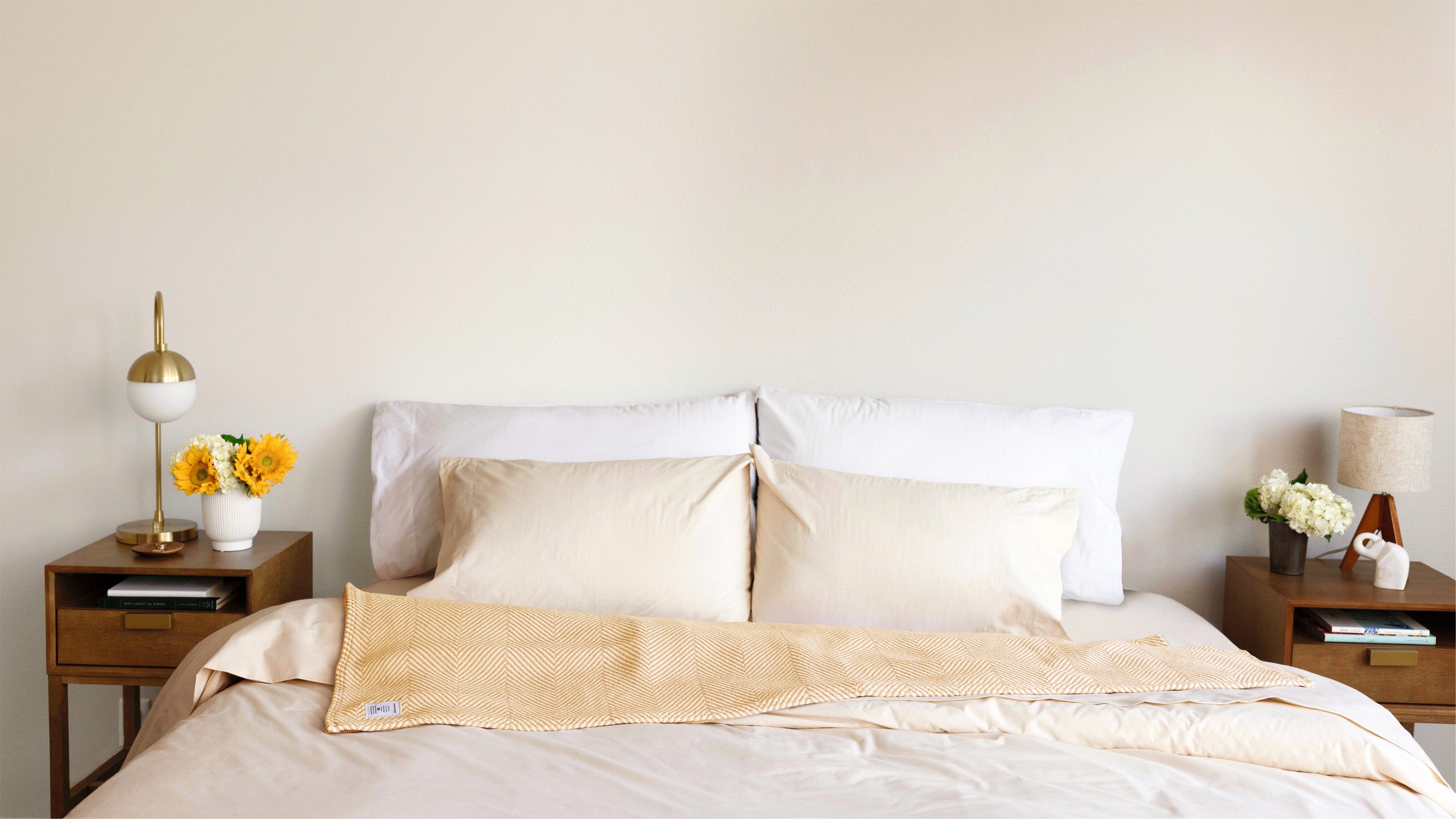 Bed made with Authenticity50 bedding and home goods.