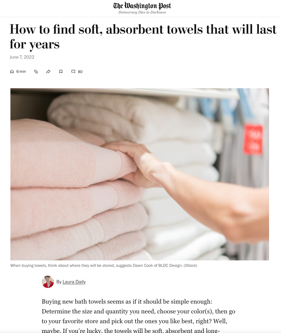 Article from The Washington Post about finding soft, absorbent towels with a hand reaching for a stack of pink towels.