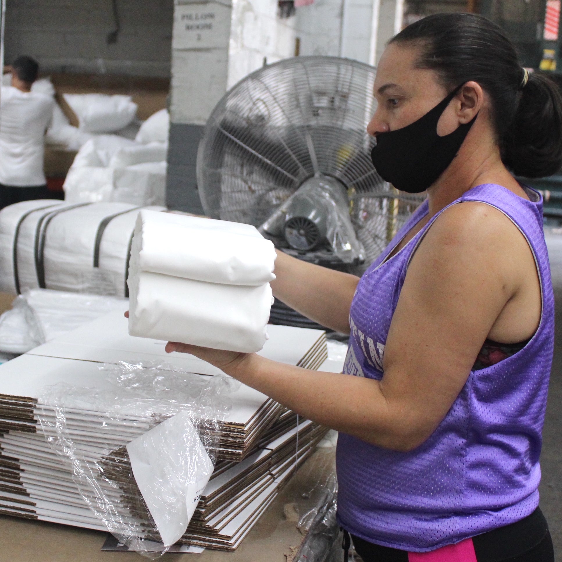 American worker packaging sheets into boxes. 