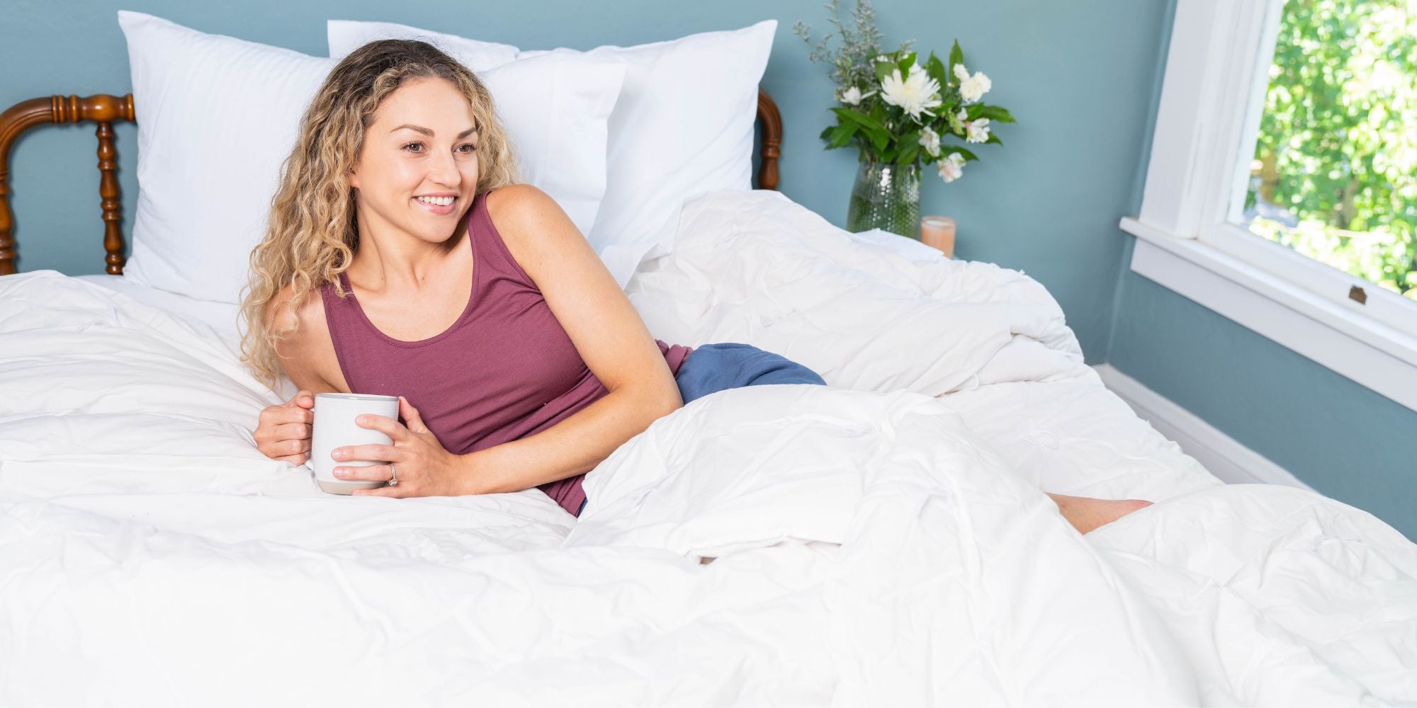 lady lying on top of a cotton duvet cover and made in usa sheets