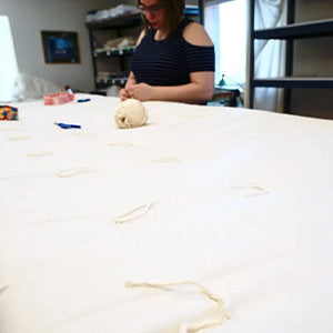 People hand knotting wool Comfort Temp Duvets.