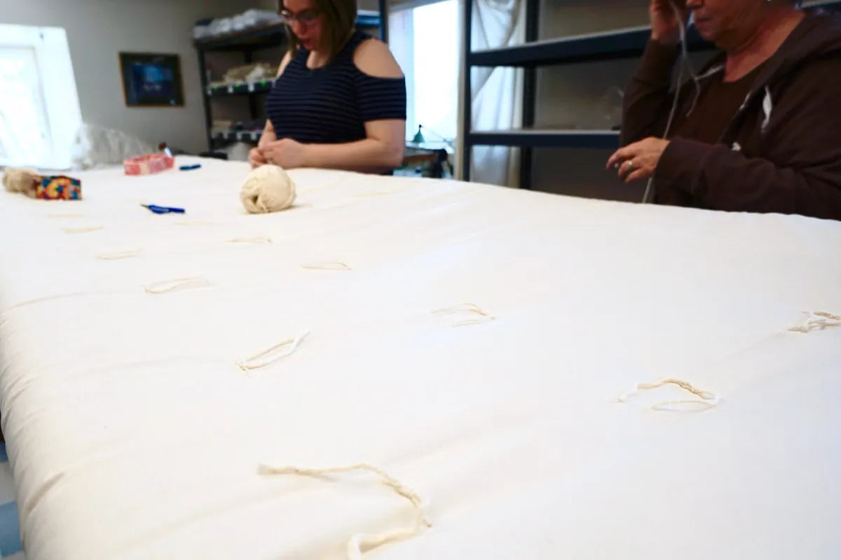 People hand knotting wool Comfort Temp Duvets.