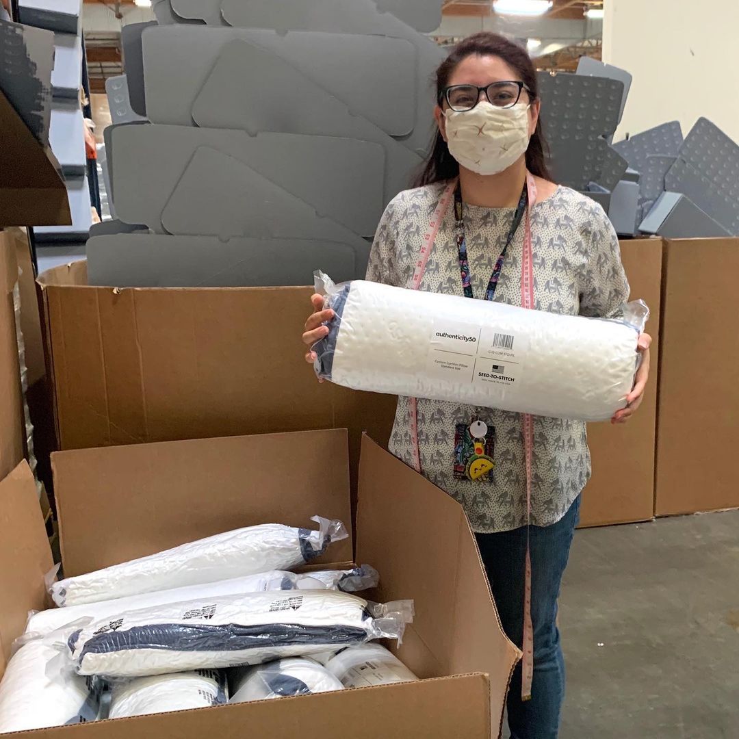 american worker holding Authenticity50 pillows