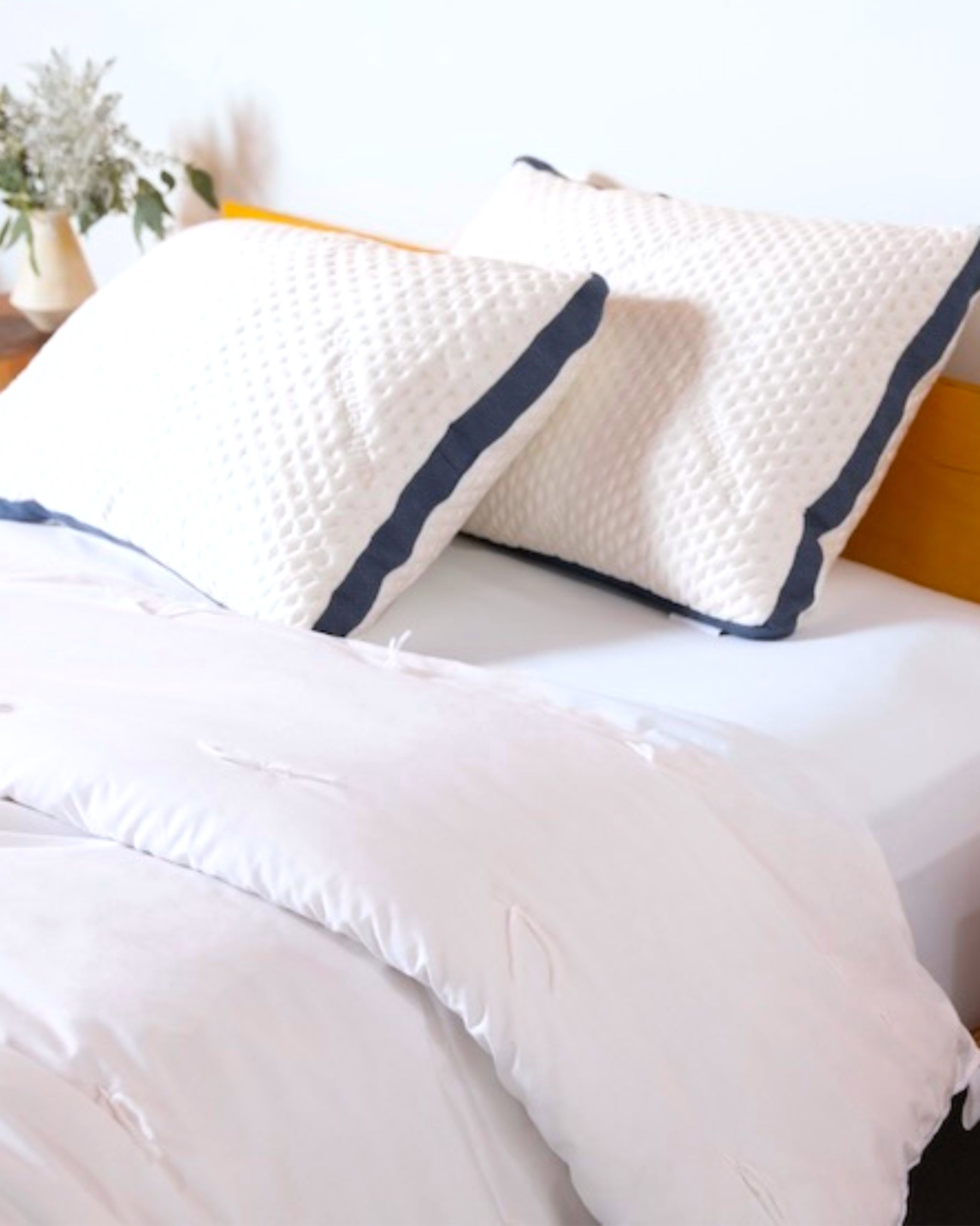 2 made in usa cooling custom comfort pillows laying on amercan made bed sheets from authenticity50