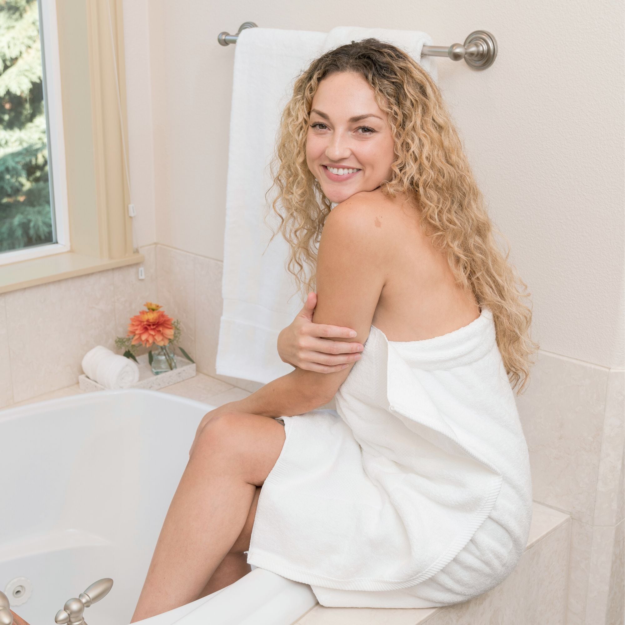 lady wrapped in white cotton bath towels