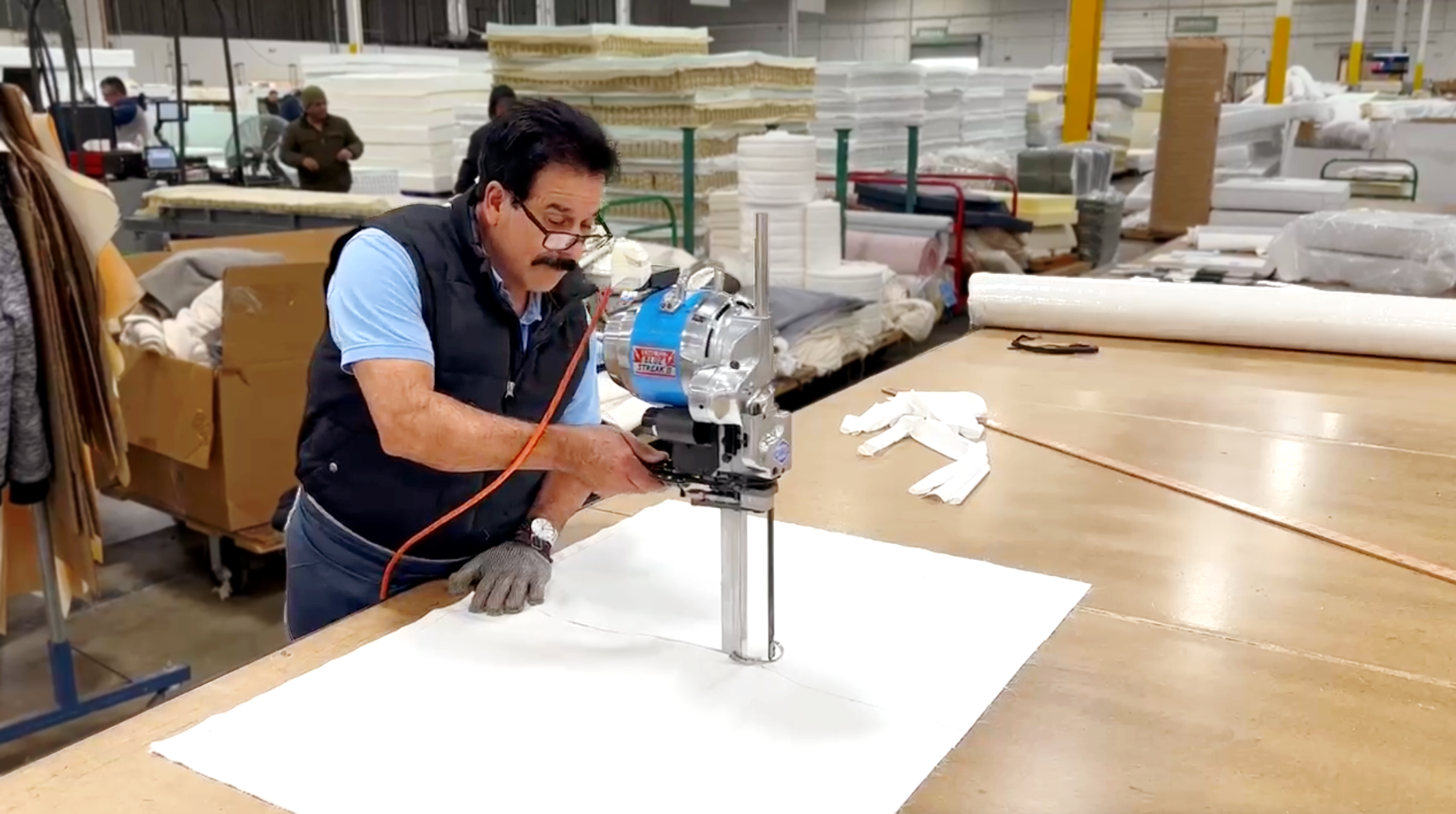 Man cutting up sheeting fabric to use for the Envelope Closure Pillowcases.
