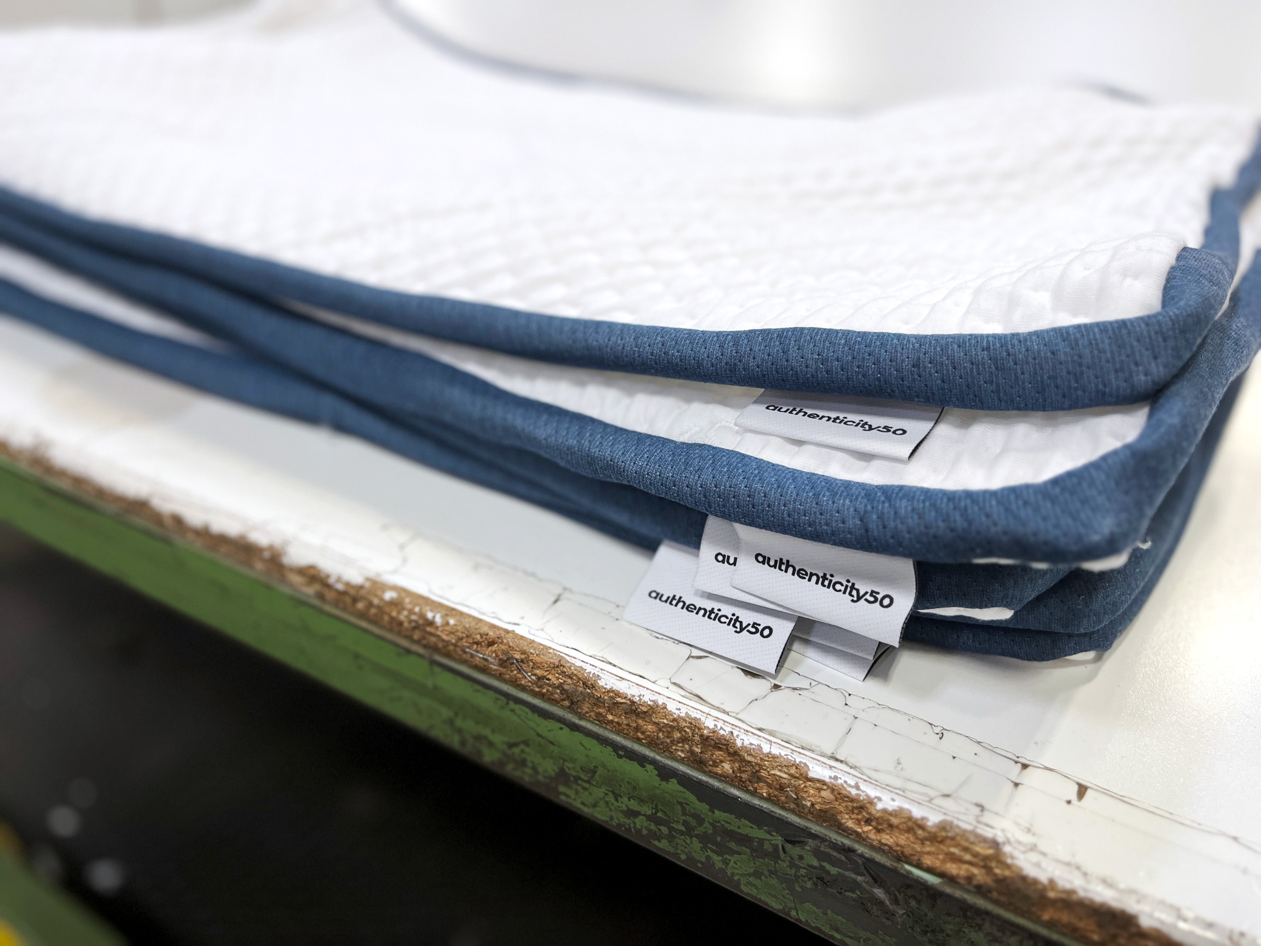 Stack of empty A50 Travel Pillow outer covers.