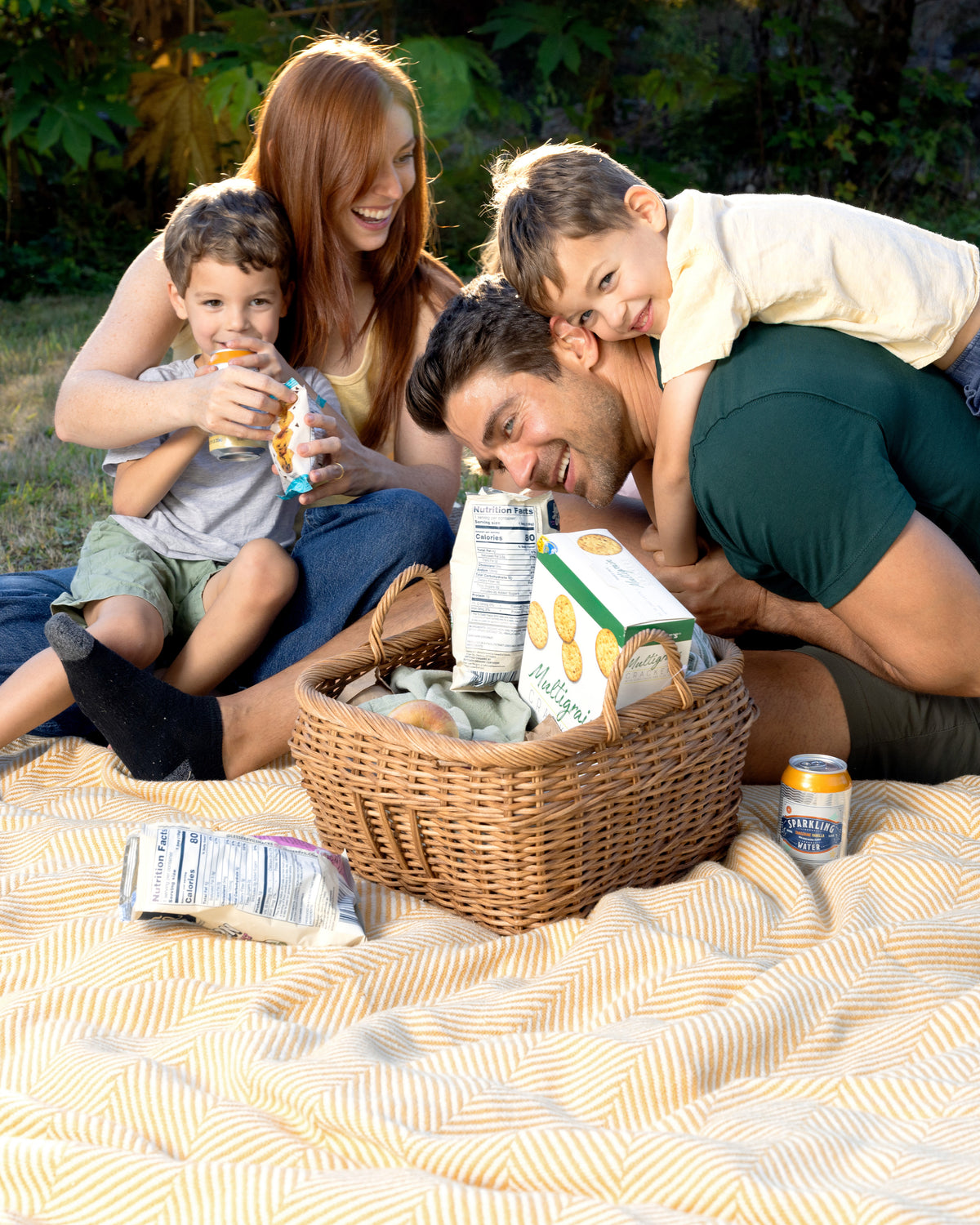 Family enjoying a picnic on their Prairie Yellow Heritage Blanket.