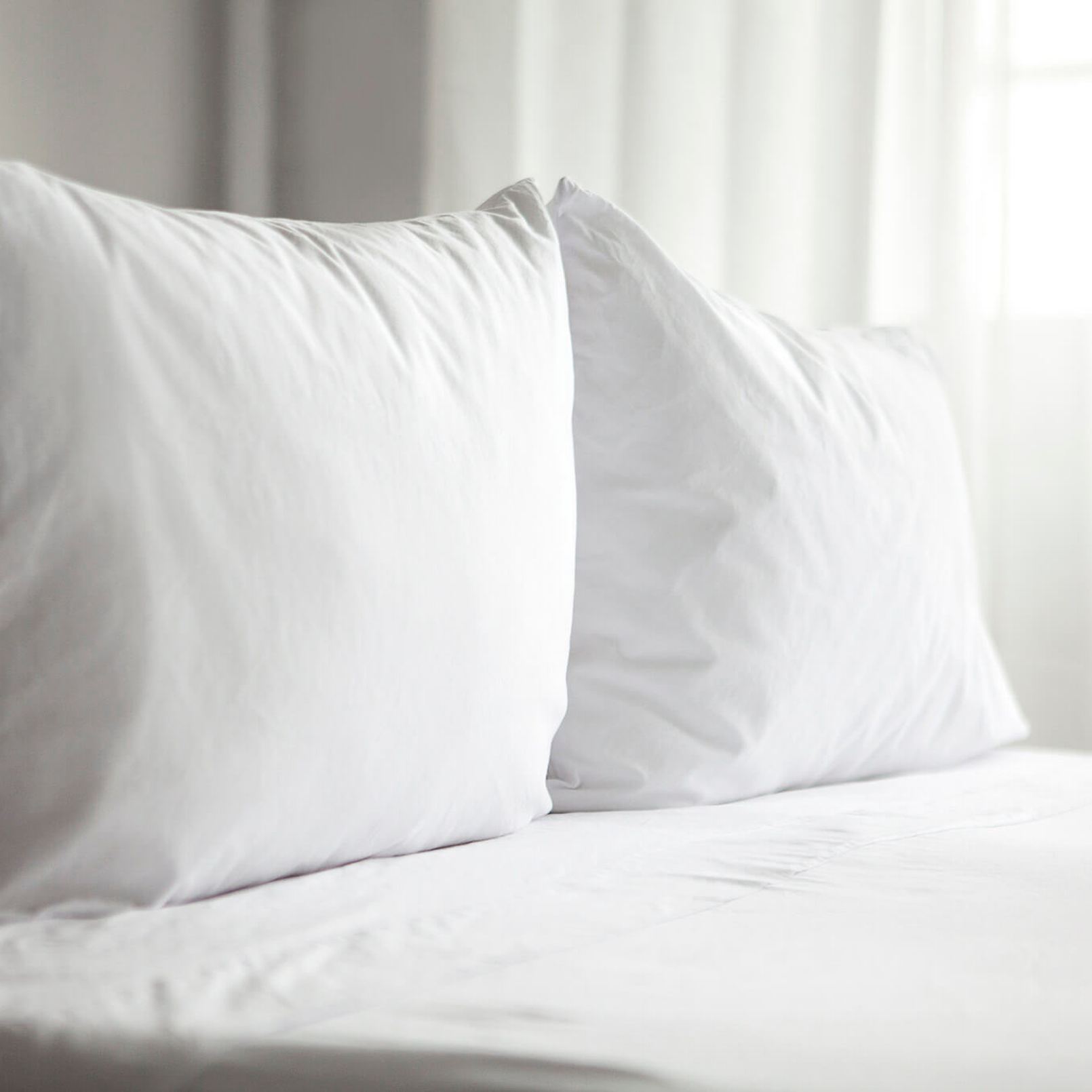 Set of Cloud White Heritage American Sheets on a bed.