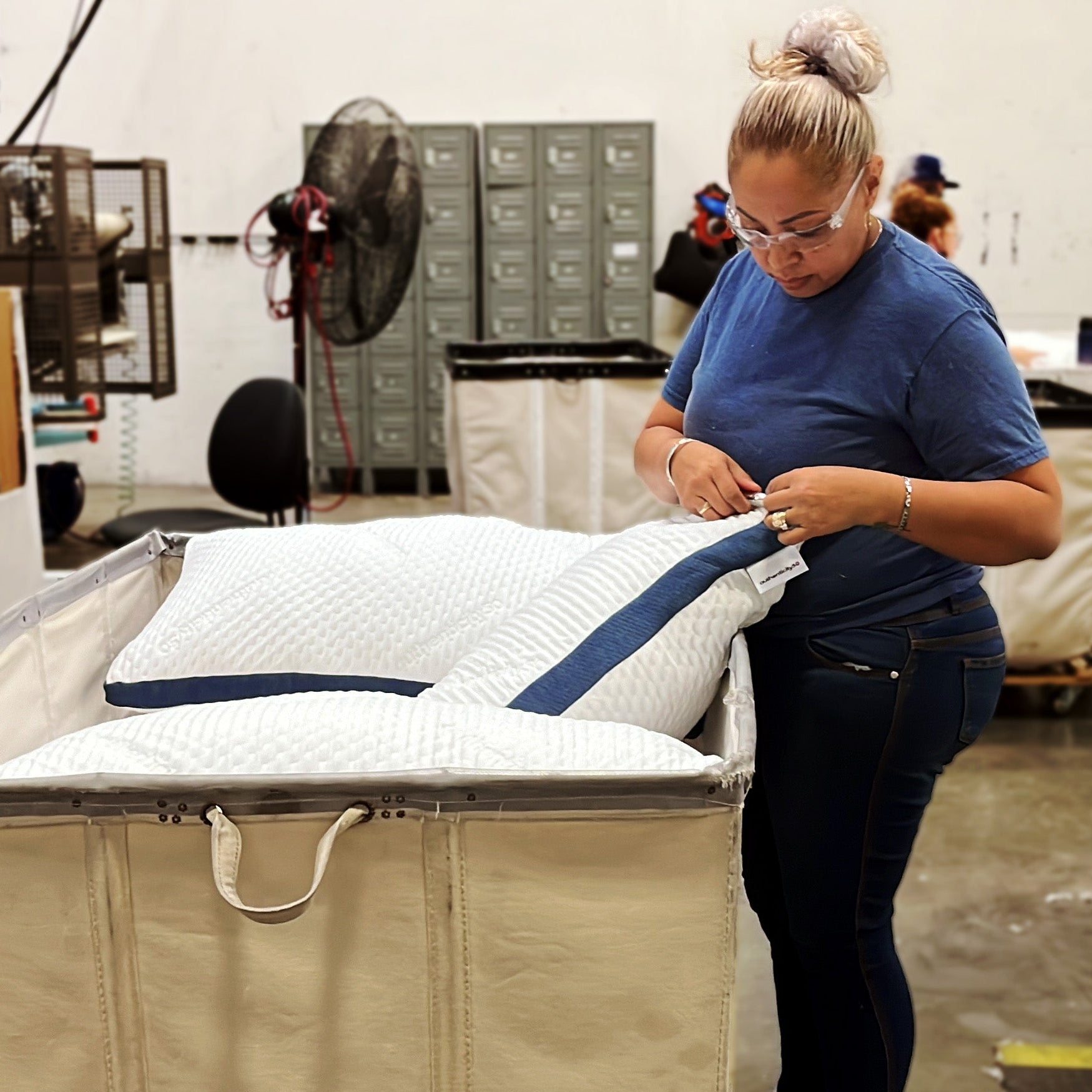 Woman putting the final touches on a batch of Custom Comfort Pillows.