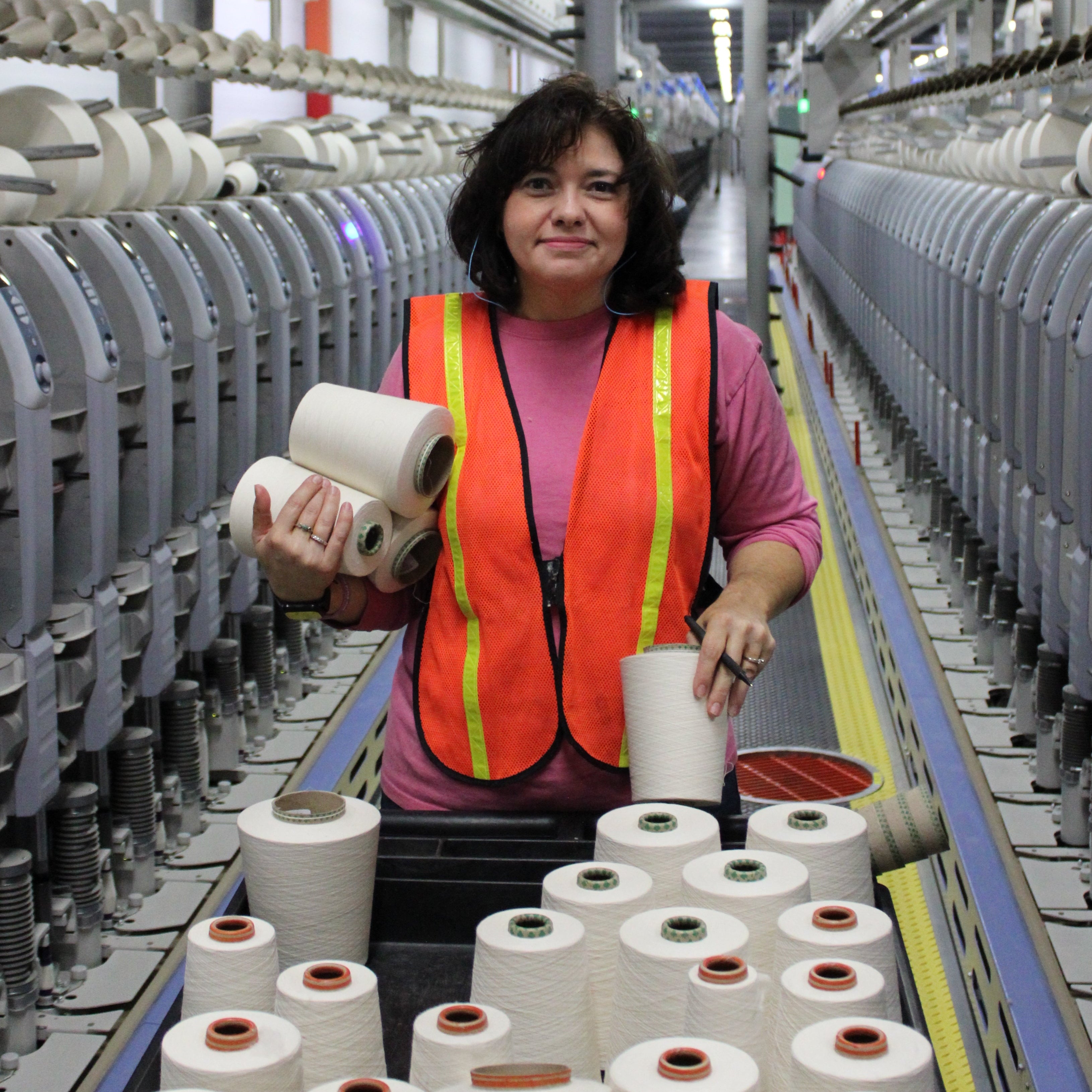 Woman woking in a North Carolina manufacturing plant to make our Heritage American Sheets.