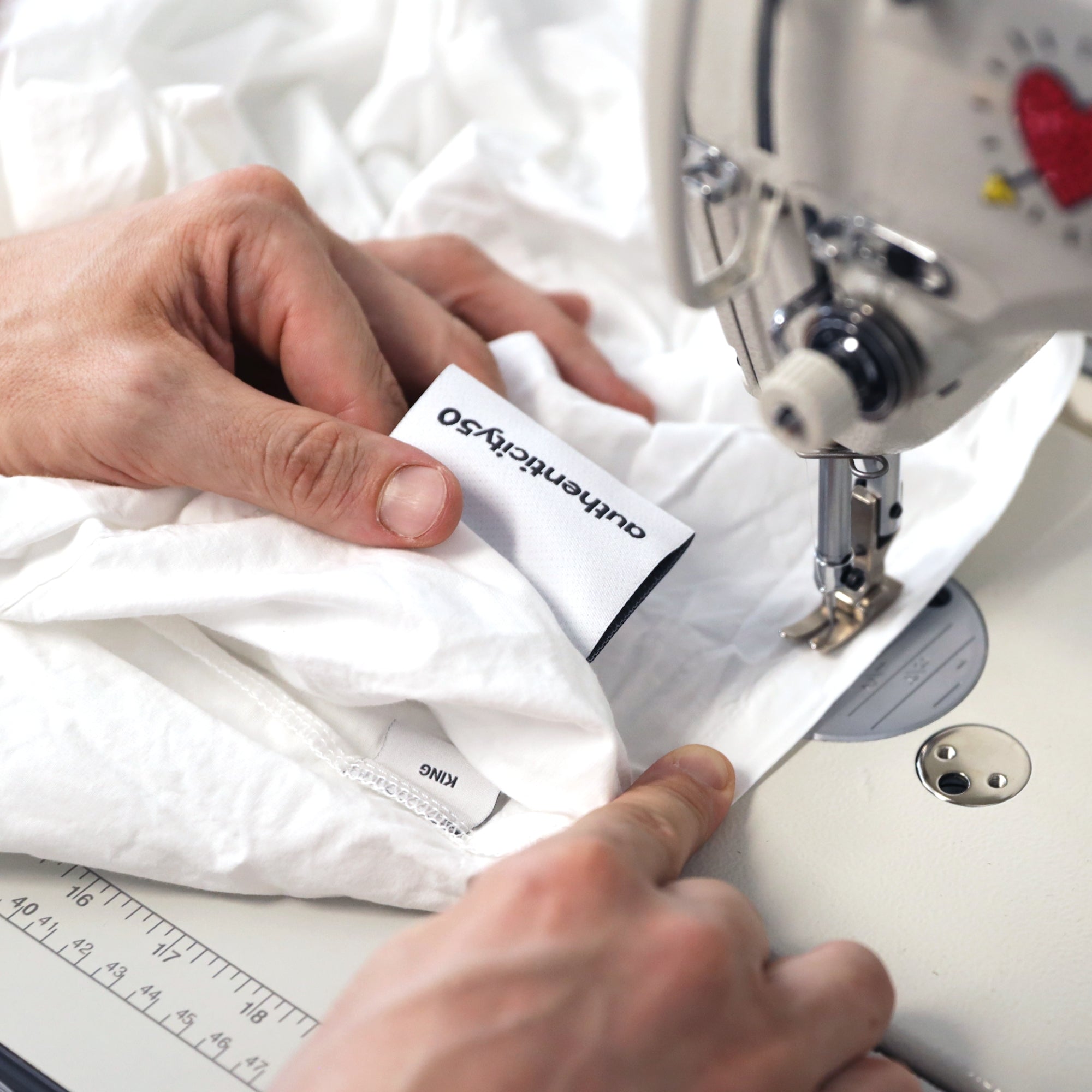 Stitching a new tag on sheets