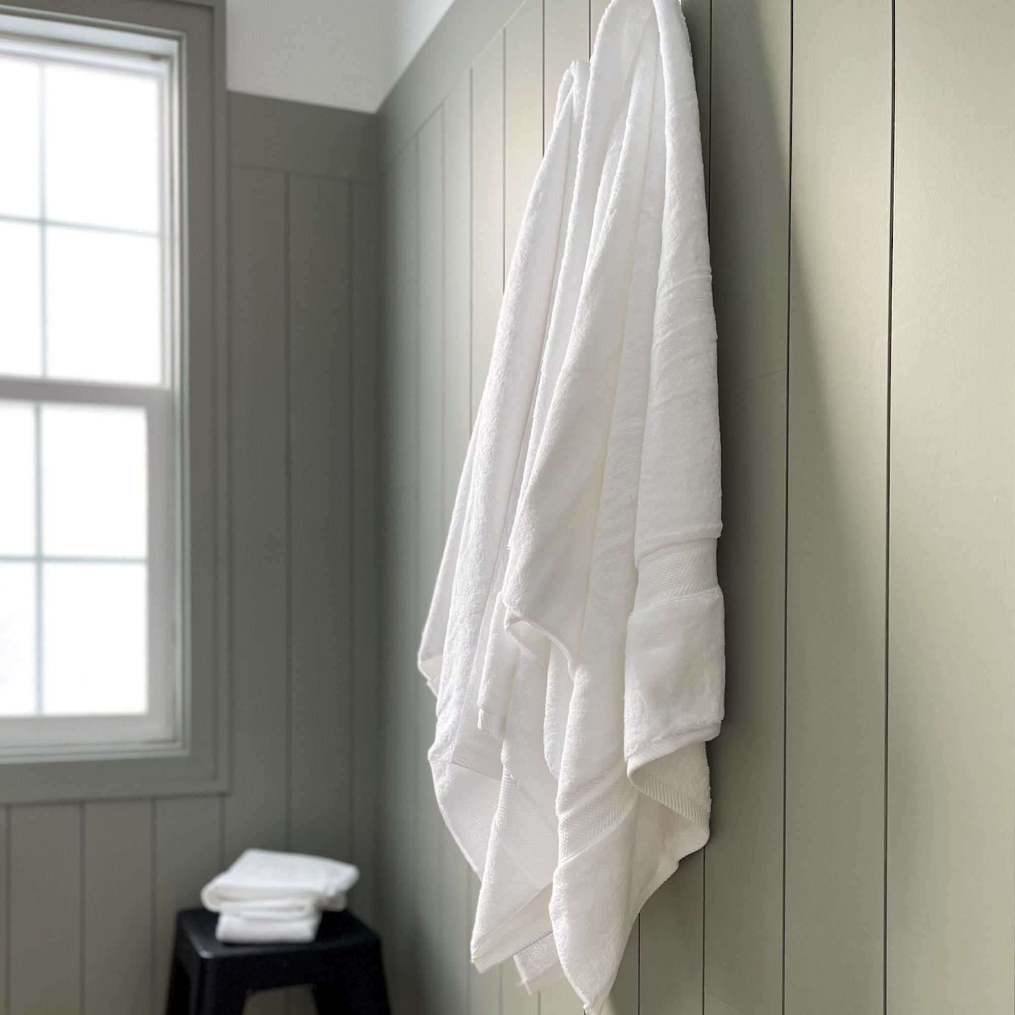 thick cotton towels hanging in the bathroom