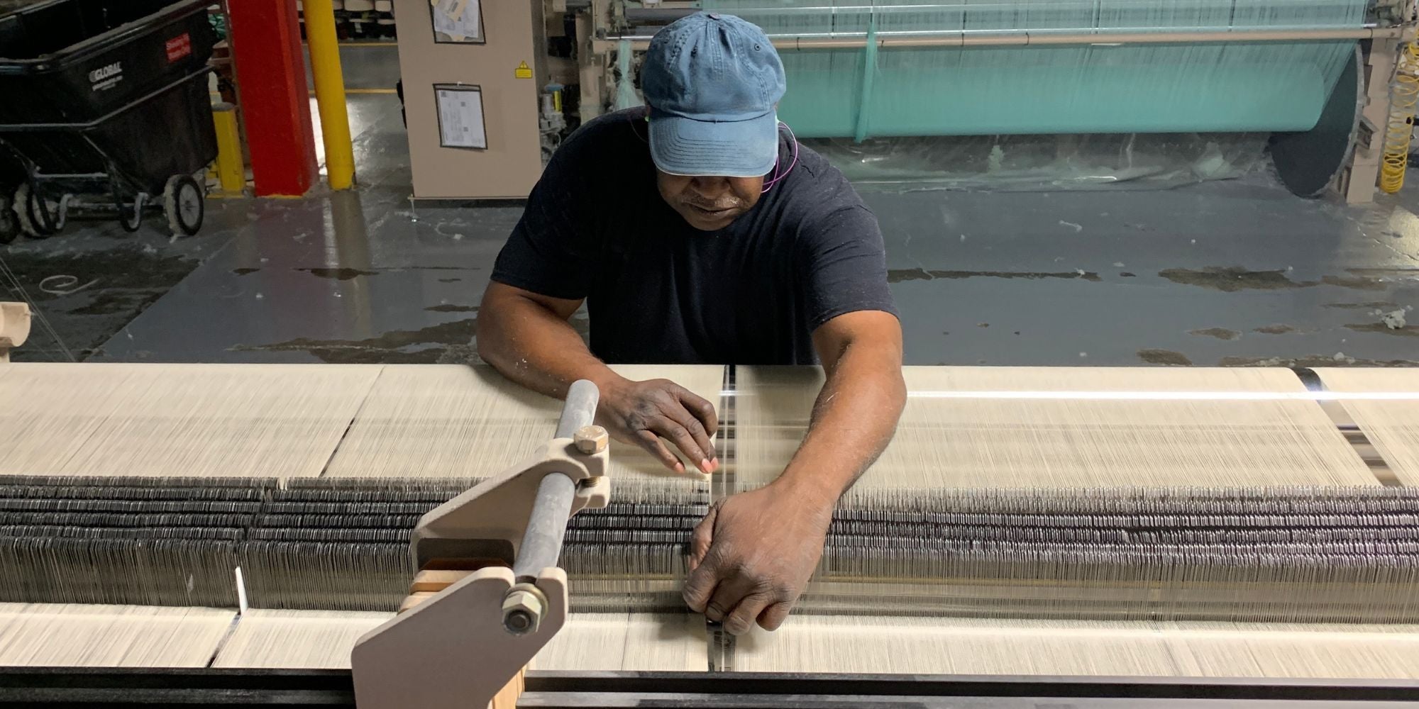 man working on looms for american made textiles
