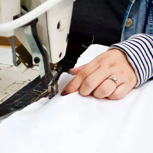Person sewing a Custom Comfort Pillow.